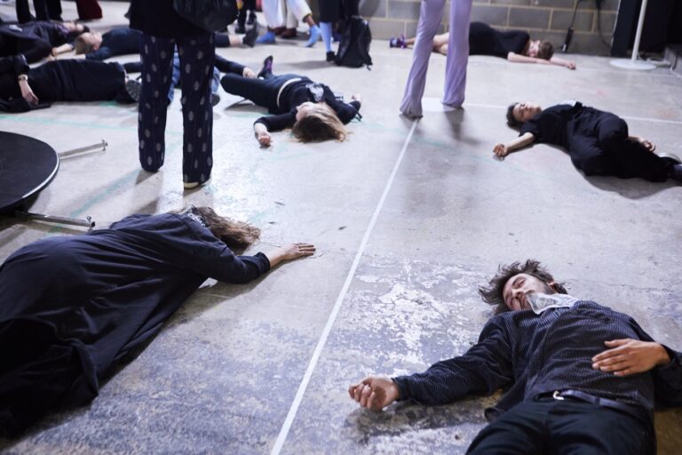 A group of people lying on the ground Description automatically generated