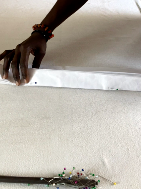 A hand holding a white object Description automatically generated