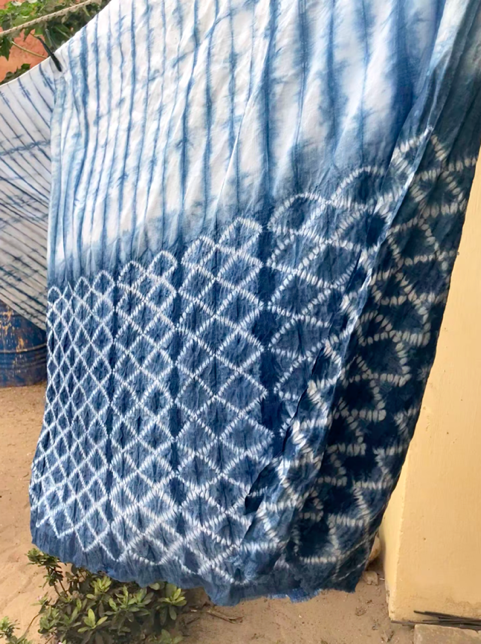 A tie dye fabric on a metal rod Description automatically generated